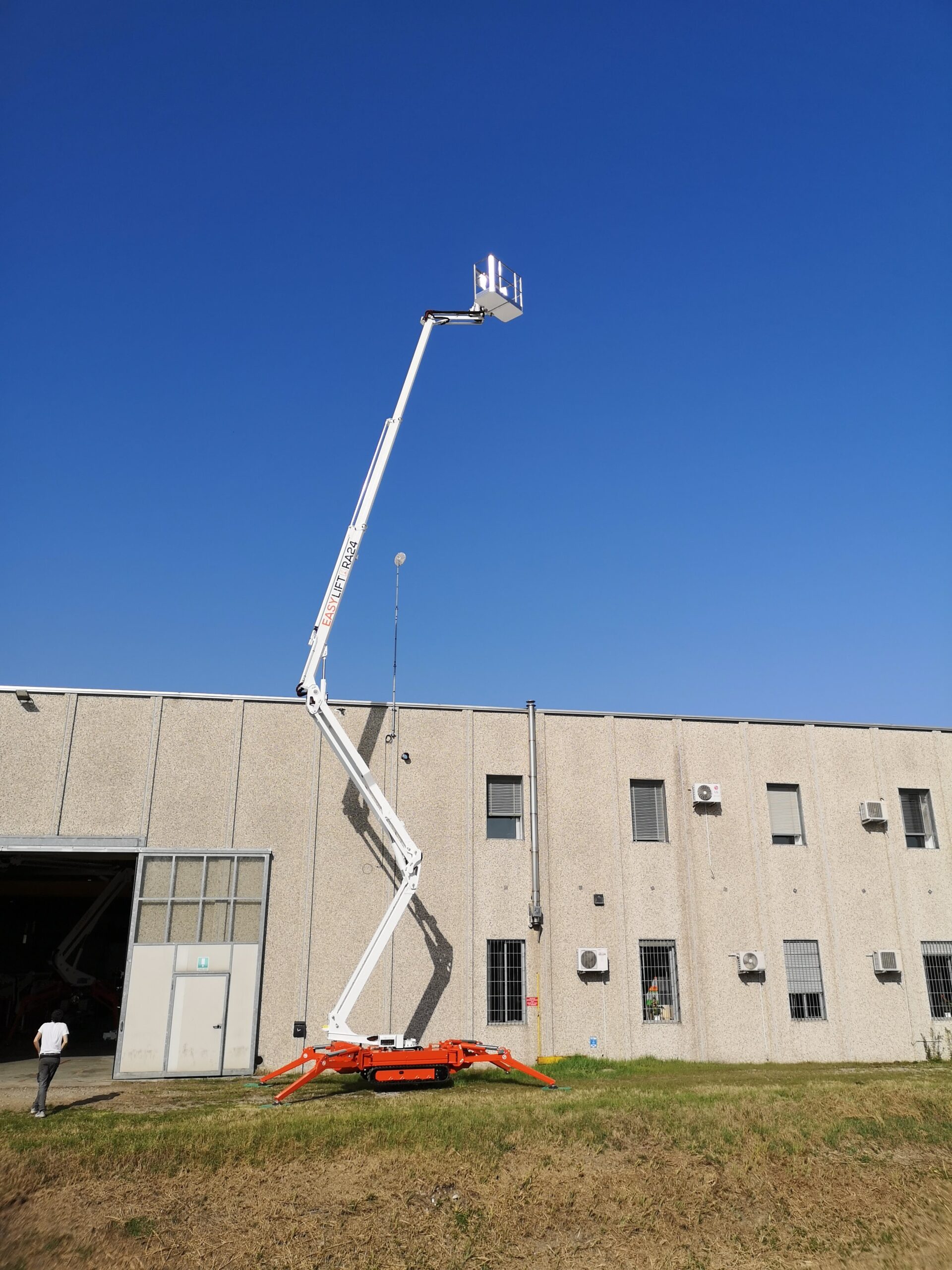 77-40AJ fully deployed beside a warehouse